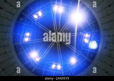 Light from blue spotlights shines from the roof of the concert hall. Stage lights. Bright lights. Event Poster Concept. Stock Photo