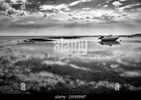 Motor boat beached by low tide at French Atlantic coast. Picturesque landscape in Vendee department, close to La Tranche sur Mer. Beautiful reflection Stock Photo