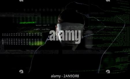 Cyber criminal in white mask hacking security system, illegal activities, attack Stock Photo