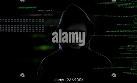 Hacker in white mask stealing important information from server terrorist attack Stock Photo