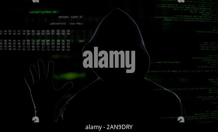 Anonymous hacker stealing secret corporate information, data system attack Stock Photo