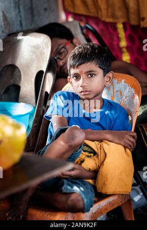 Batu Caves, Malaysia - January 21 2019 : Close-up of young boy devotee sitting on the chair in Thaipusam Festival.