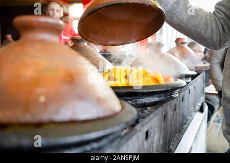 Delicious moroccan tajine prepared and served in clay pots, Marrakech Stock Photo