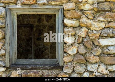 A window from an old building that was used as a garage and gas station that my Grandpa used to own and run in the 1950's still stands in Dunnegan Mis Stock Photo
