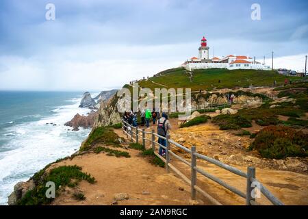 Lighthouse on the most western part of Europe with many tourist in foreground, Cabo da Roca, Portugal Stock Photo