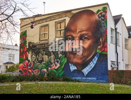 Mural Clifford Drummond on the end wall of a row of terraced houses on the Seven Saints of St Pauls trail in the centre of Bristol UK
