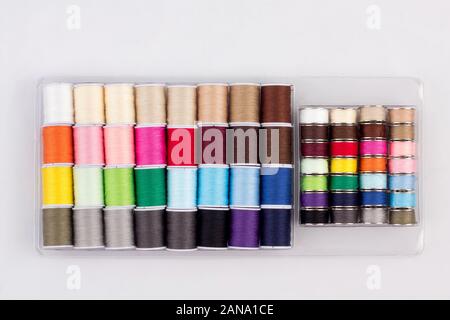 colorful of cone threads in packaging isolated on white background Stock Photo