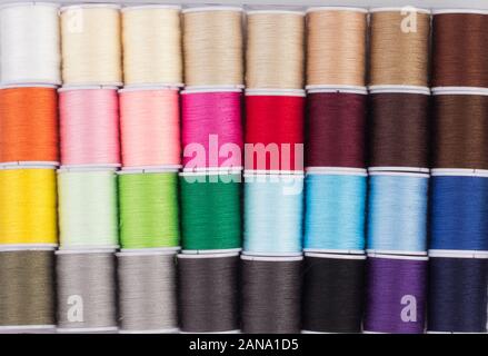 close up of colorful cone of threads, sewing tool Stock Photo
