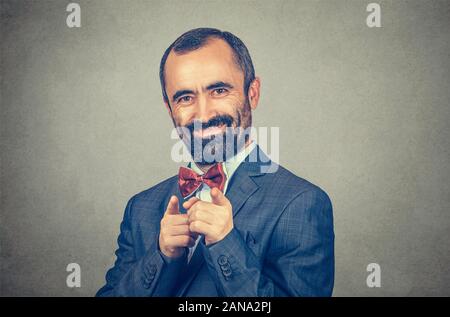 Closeup portrait of man in suit, smiling businessman pointing at you camera with both index fingers. Mixed race bearded model isolated on gray studio Stock Photo