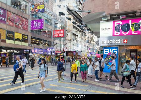 Kowloon Hong Kong street scene - people walking, Tsim Sha Tsui district, Kowloon Hong Kong Asia; concept of capitalism and western culture Stock Photo