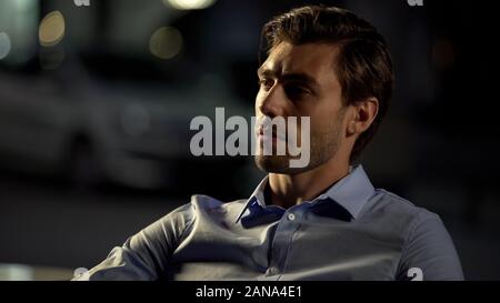 Pensive businessman sitting in cafe, tired after hard day, waiting for drinks Stock Photo