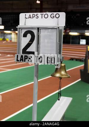 A lap counter with a bell to ring when there is one lap to go, is set up next to the finish line to show runners how many laps they have to run in an Stock Photo