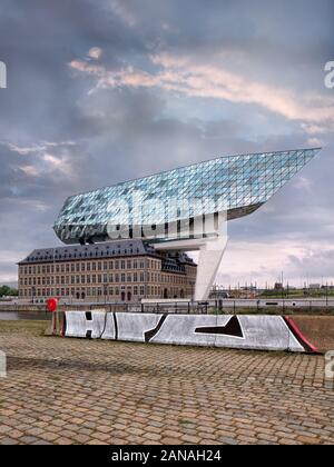 ANTWERP-JUNE 5, 2019. Port House Antwerp at twilight. Zaha Hadid Architects added a glass extension to a renovated fire station. Stock Photo