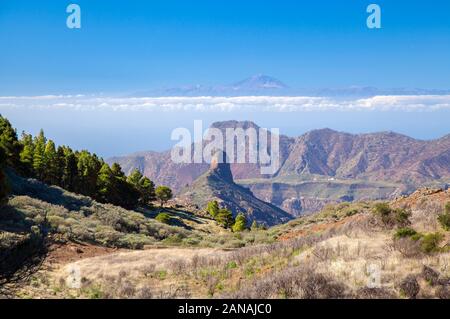 Gran Canaria, January, view along a small valley, rock formation Roque Bentayga,mountain range Altavista and Teide on Tenerife lined up Stock Photo