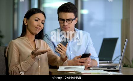 Engineers testing new smartphone, disappointed with software quality, test group Stock Photo