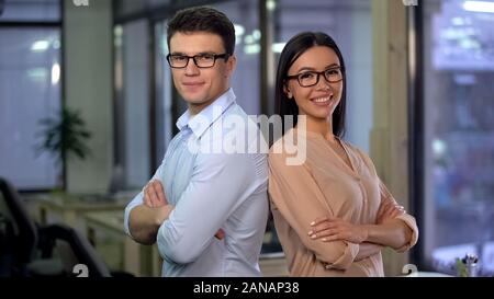 Male and female office workers looking in camera, professional business partners Stock Photo