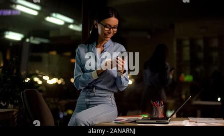 Young asian lady chatting by smartphone, social networks app, communication Stock Photo