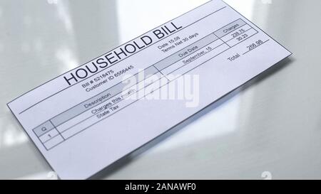 Household bill lying on table, payment for services, month expenses, tariff Stock Photo