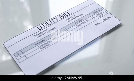 Utility bill lying on table, payment for services, month expenses, tariff Stock Photo