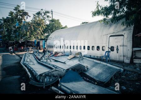 Bangkok/Thailand-06 December 2019: Bangkok airplane graveyard, detail from outdoors of a broken commercial airplane scattered on the floor. Stock Photo