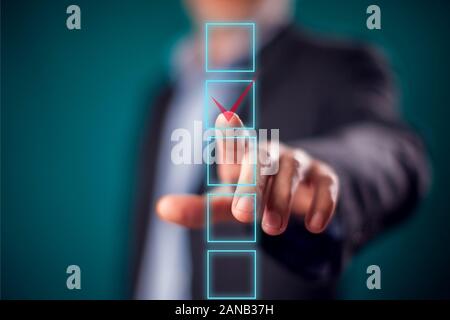 Businessman in suit click finger at checkbox.People and correct answer concept Stock Photo