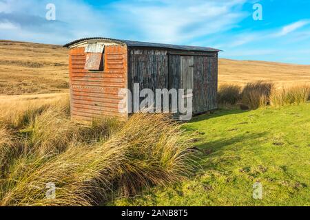 Shepherd's Hut in remote and isolated moorland near Tan Hill Inn near Keld, Yorkshire Dales.  Blue sky.  Winter.  Horizontal. Space for copy. Stock Photo