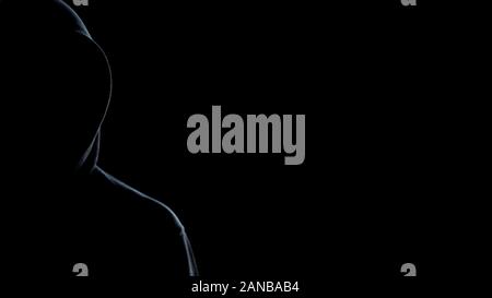 Silhouette of hooded man on black background, template for crime statistic Stock Photo