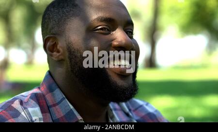 Smiling african american bearded man relaxing outdoors, enjoying life, happiness Stock Photo