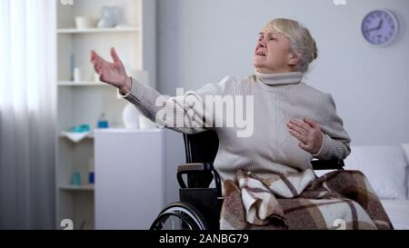 Old woman in wheelchair feeling chest pain, asking help, heart attack, hospital Stock Photo