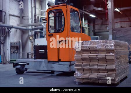 Timber Flooring Factory. Pile of cut wood in factory storage warehouse. Lumber in warehouse. Stock Photo