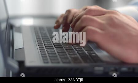 Businessman hands typing on laptop, pressing buttons on keyboard, internet Stock Photo