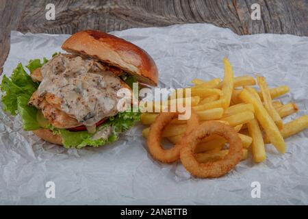 Hawaiian Burgers. Delicious fresh sandwich with chicken burger, tomato, pickles, onions and lettuce. Free space for text Stock Photo