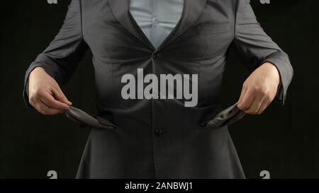 Businessman showing empty pockets, crisis and inflation, unemployment concept Stock Photo
