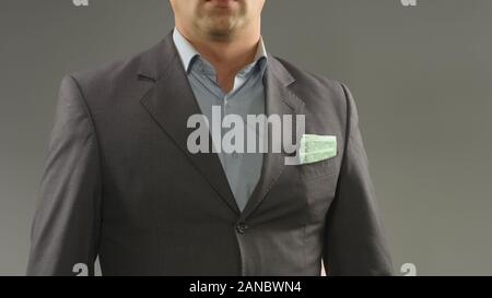 Euros in rich male suit pocket, money saving, income and successful startup Stock Photo