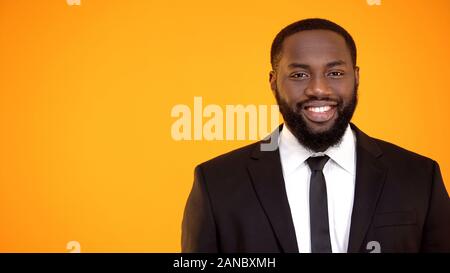 Charming afro-american man in formal suit smiling and looking to camera template Stock Photo