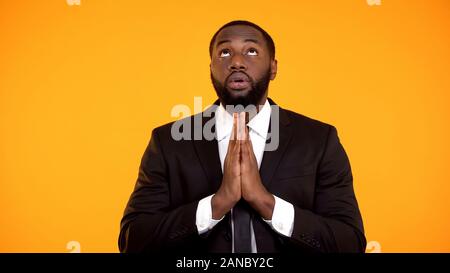 African-american male in suit praying and looking up, faith, asking for success Stock Photo