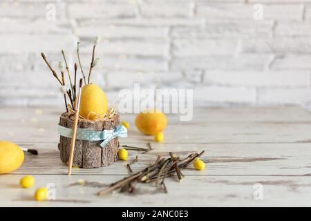 Yellow colored Easter eggs on wooden table. Happy Easter time. Creative Easter decoration. Copy space. Stock Photo