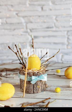 Yellow colored Easter eggs on wooden table. Happy Easter time. Creative Easter decoration. Stock Photo