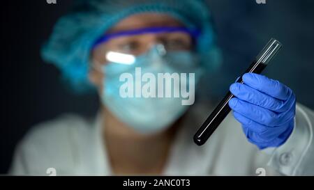 Lab worker checking soil sample in tube, agricultural experiment, fertility Stock Photo