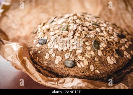 Whole Grain Traditional Rye Bread in Brown Parchment Paper Stock Photo