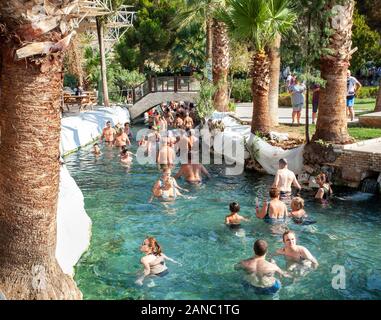 Pamukkale, Turkey- September 7, 2019: Many people walk and swim in the Cleopatra pool. Stock Photo