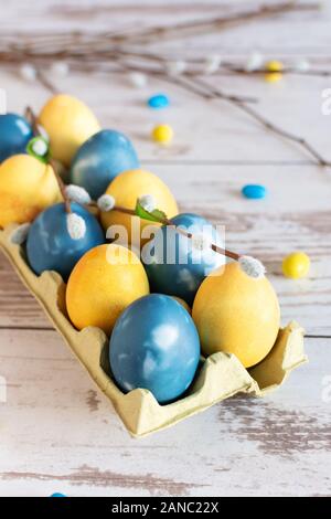 Marble blue and yellow colored easter eggs on wooden table. Easter holiday card. Stock Photo