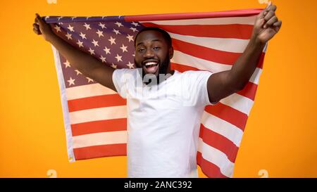 African-American man holding US flag, independence day celebration, holiday Stock Photo