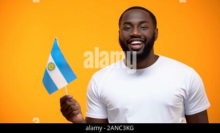 Afro-American man holding Argentine flag, independence day celebration, holiday Stock Photo