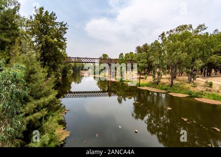View of the iron rail bridge over the Macquarie River built in 1884 and known as the Lattice Railway Bridge in Dubbo, New South Wales, Australia Stock Photo
