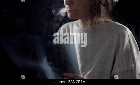 Frustrated woman with cigarette looking at lungs x-ray, incurable disease Stock Photo