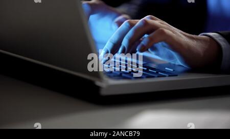 Female hands typing on laptop keyboard at night, modern technologies, freelance Stock Photo