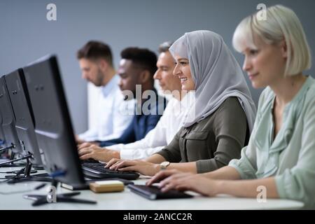 Group Of Young Businesspeople Working On Computer Stock Photo