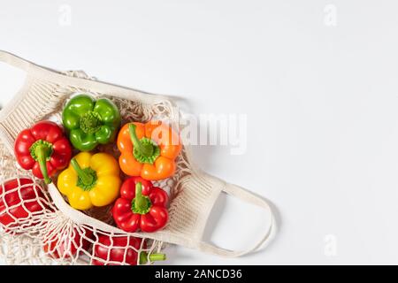 Zero waste concept. Vegetables in eco friendly reusable string bag on white background. Plastic free. Healthy fresh vegetarian food. Flat lay Stock Photo