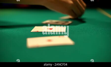 Croupier laying out cards on table, poker and blackjack casino games, fortune Stock Photo